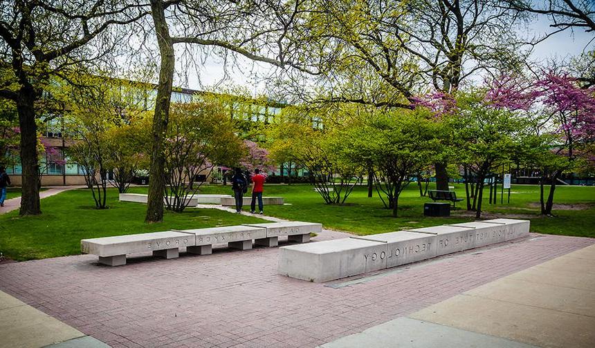 Students walking outside on Mies Campus in the Pritzker and Galvin Grove