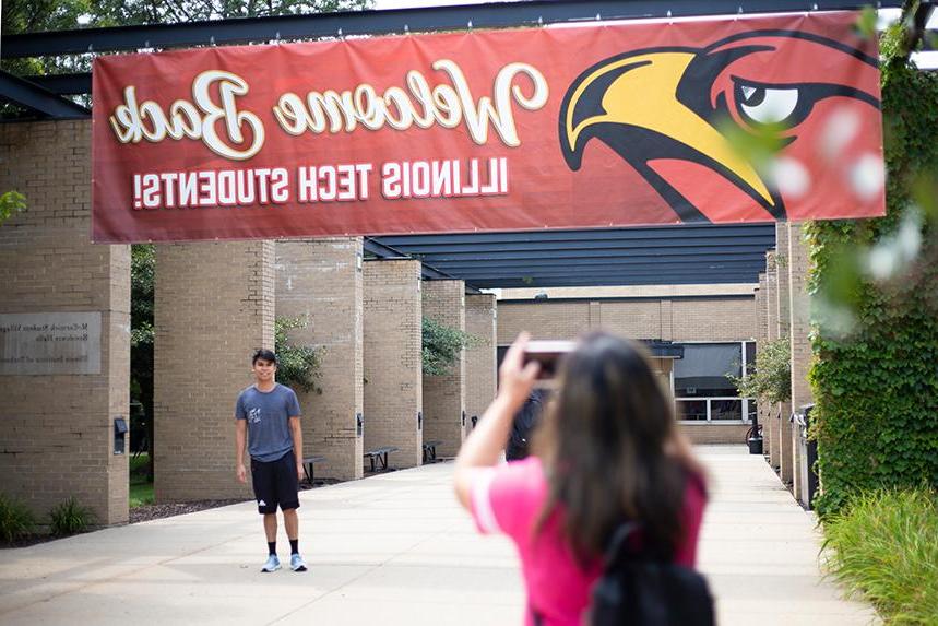 A family member taking a photo of an incoming student outside of MSV