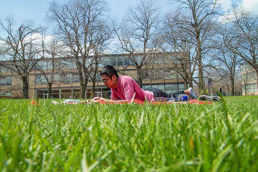 A student studying outside on Mies Campus