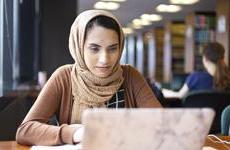 A Chicago-Kent Student studies in the Law Library