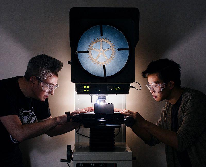 Machine Shop students working with Microscope